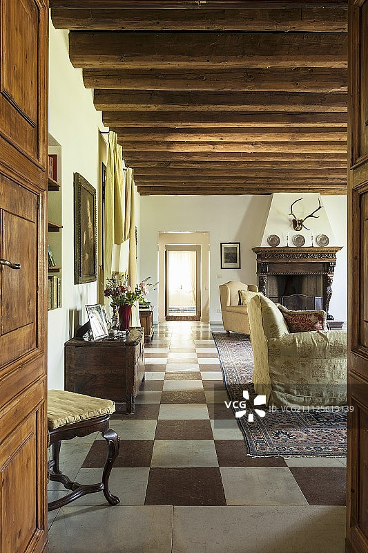透过开敞的门，可以看到休息室，那里有质朴的木梁天花板和方格地板图片素材