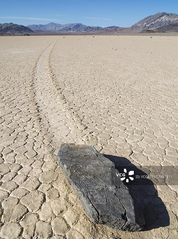由一块神秘的移动岩石在“赛马场”创造的轨道，一个干燥的湖床或盐湖，死亡谷，死亡谷国家公园，美国，美国，北美图片素材
