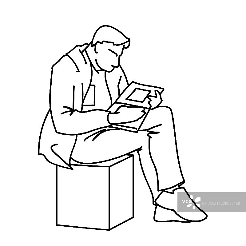 一个成年人正坐在一个立方体上看书图片素材