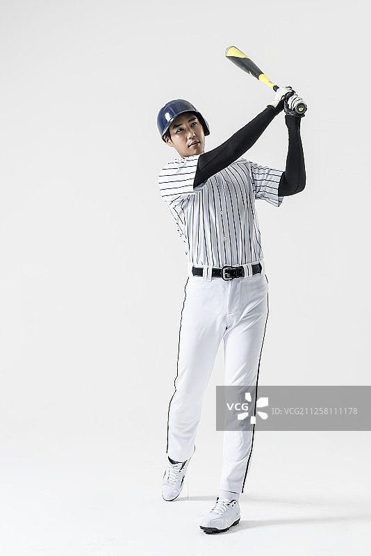 棒球运动员挥动棒球棒的摄影图片素材