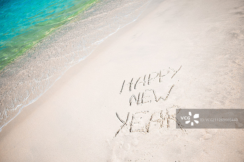 新年快乐写在沙里图片素材