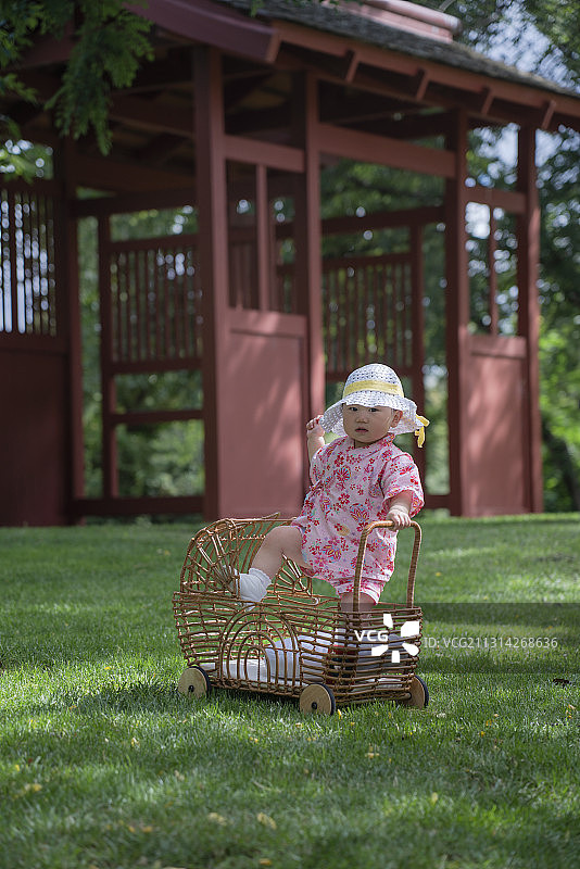 奈良公园草坪藤车里的红粉女婴图片素材