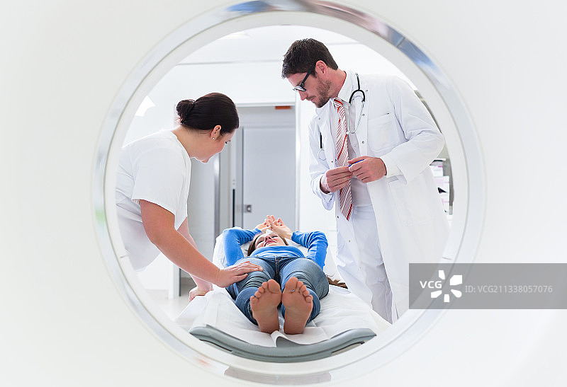 医生、护士和病人在医院进行CT断层扫描时，被射穿了导管装置图片素材