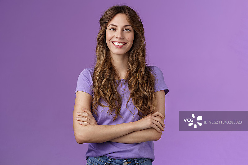 微笑的年轻女子肖像站在紫色的背景图片素材