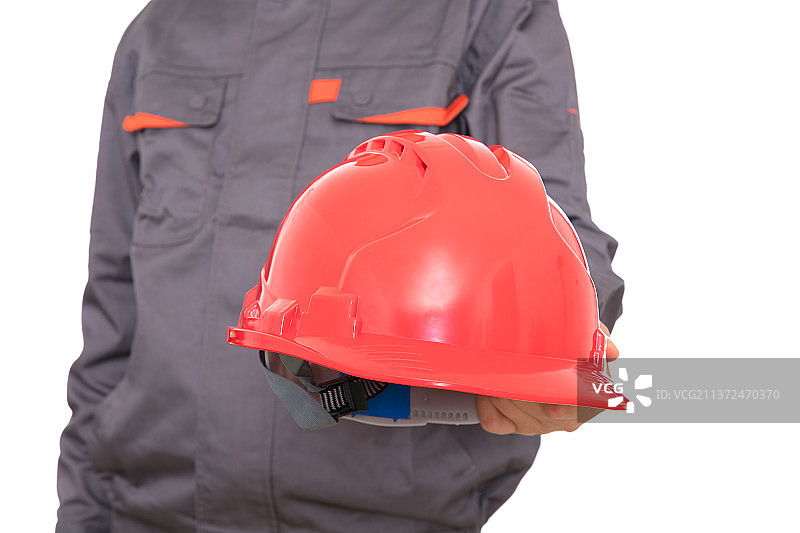 建筑工人手里的红色安全帽图片素材