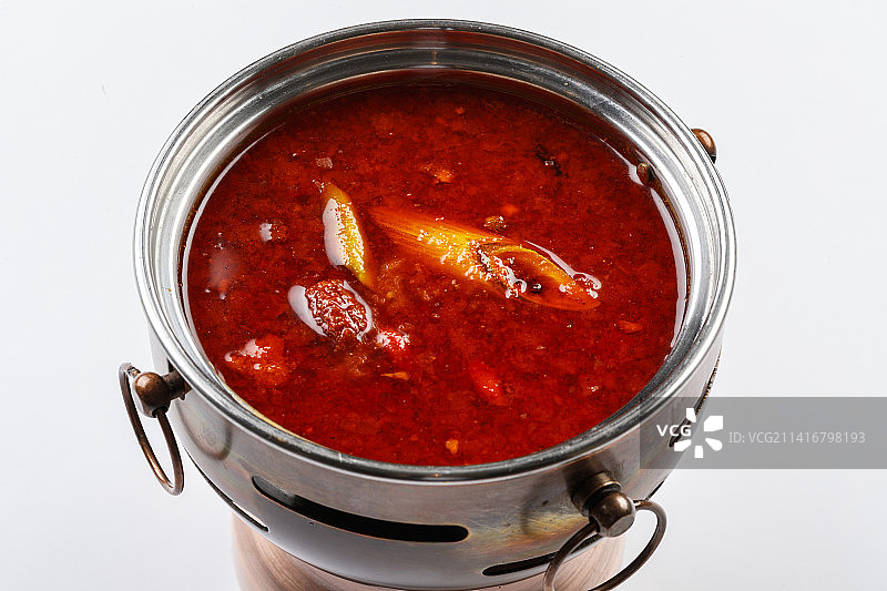 白色背景上的小火锅装的香辣红油锅底图片素材
