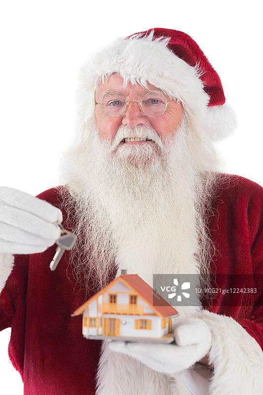 圣诞老人将白色背景下一座小房子的钥匙递给他图片素材