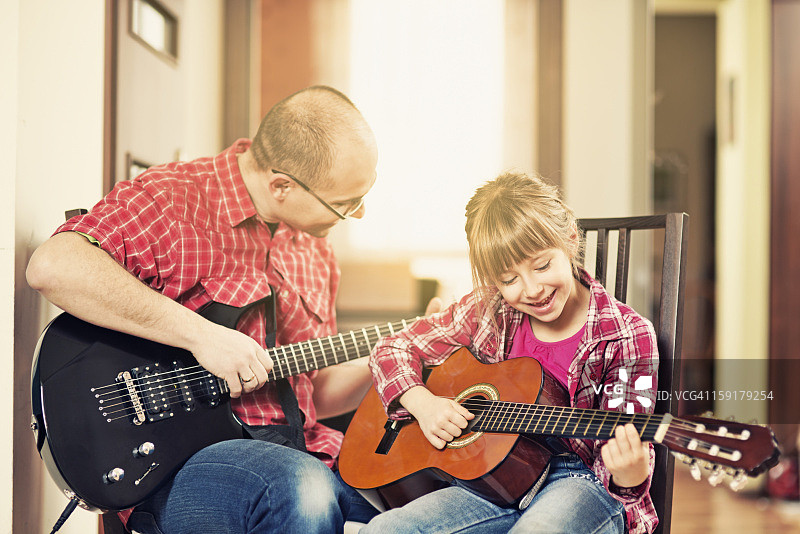 父亲和女儿一起弹吉他图片素材