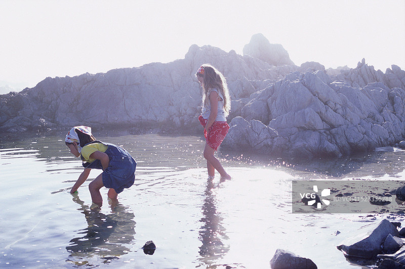 在洛基海岸玩水的两个女孩图片素材