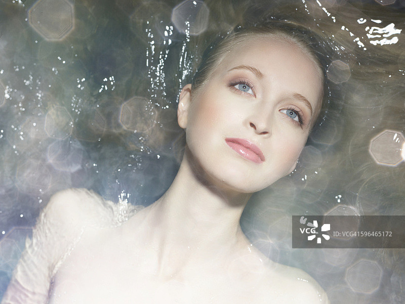 一个女人躺在水里的美丽肖像图片素材