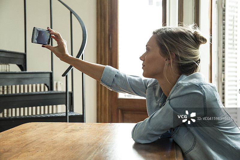 女人用智能手机自拍图片素材