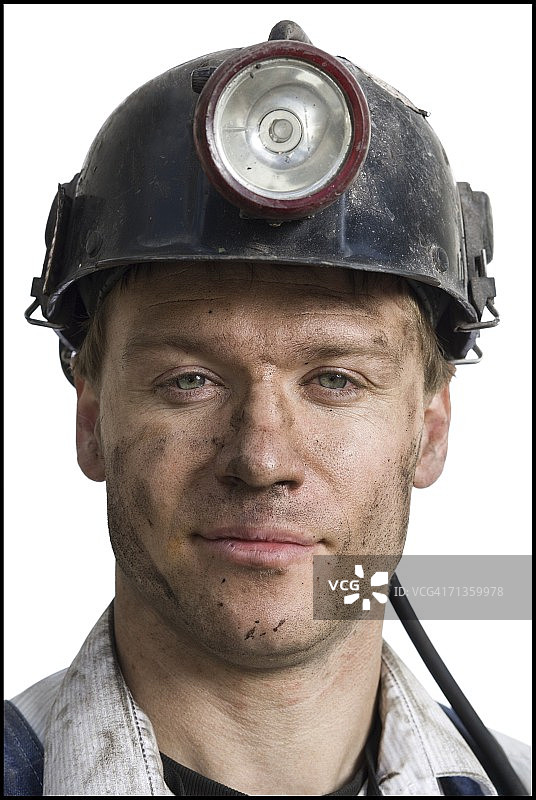 一个戴安全帽的矿工的肖像图片素材