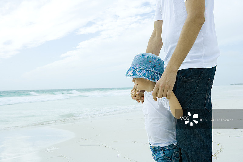 一个男人和儿子站在海滩上图片素材