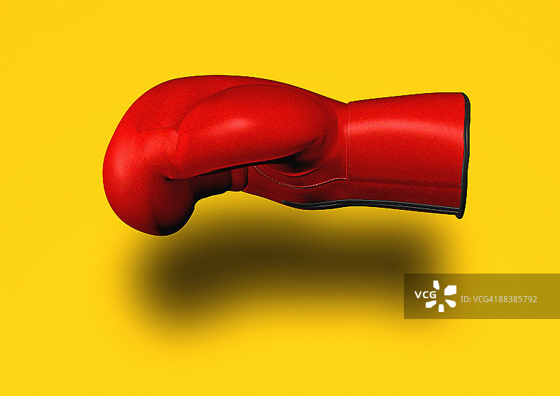 黄色背景上的红色拳击手套图片素材
