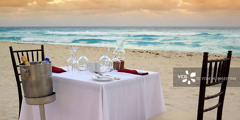新婚夫妇在海滩上的餐桌布置。图片素材