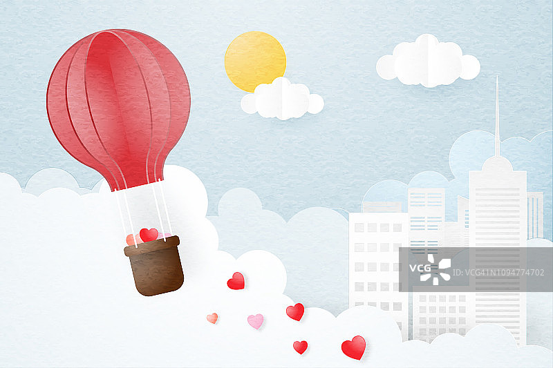 创意情人节概念。折纸热气球飞过城市和云的背景。图片素材