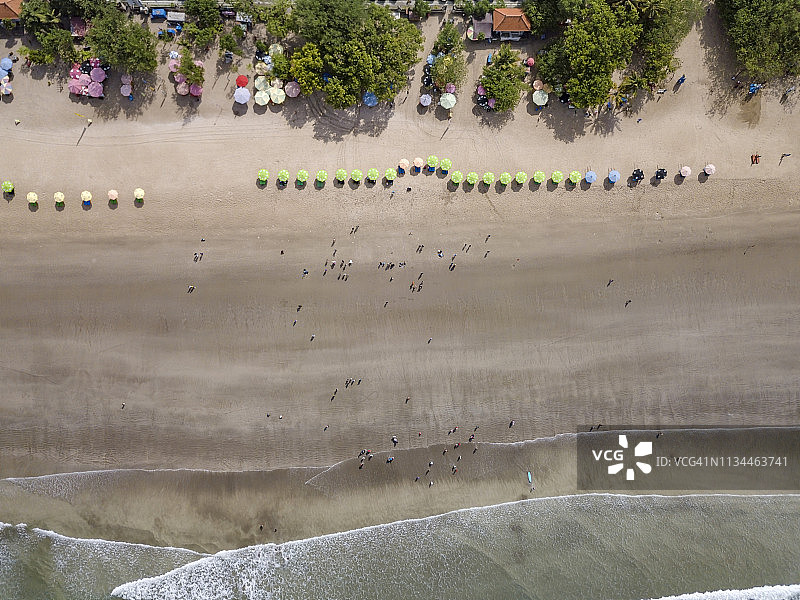 巴厘岛库塔海滩，排着沙滩伞和人们在沙滩上，鸟瞰图片素材