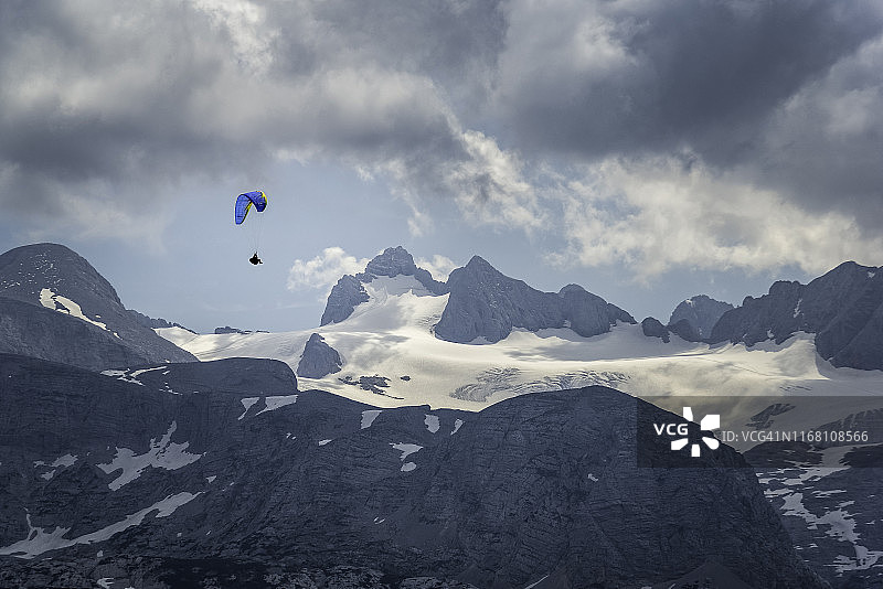 奥地利奥伯特朗，以戏剧性的天空为背景，在欧洲阿尔卑斯山上空滑翔图片素材