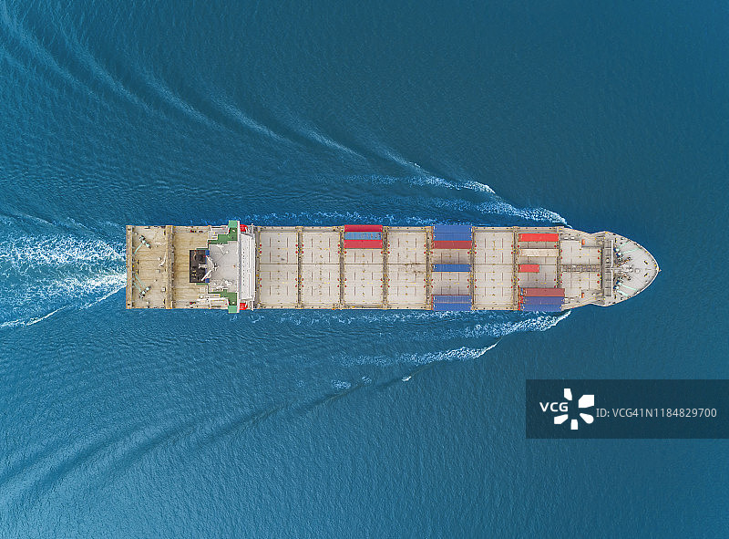 鸟瞰图集装箱货船全速与美丽的波浪型载体集装箱业务物流，进出口，航运或运输。图片素材