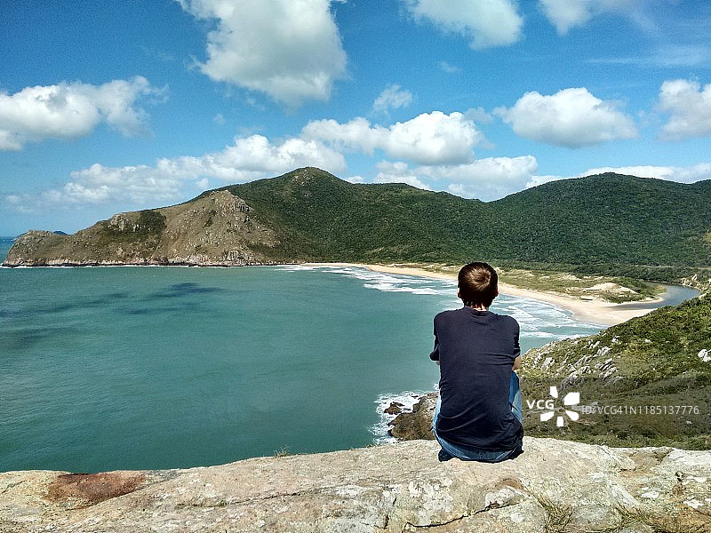在巴西圣卡塔琳娜州Florianópolis，一名男子望着未被破坏的拉古尼亚海滩图片素材