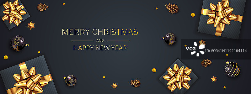 礼盒与金色的假日弓和圣诞球在黑色的背景图片素材