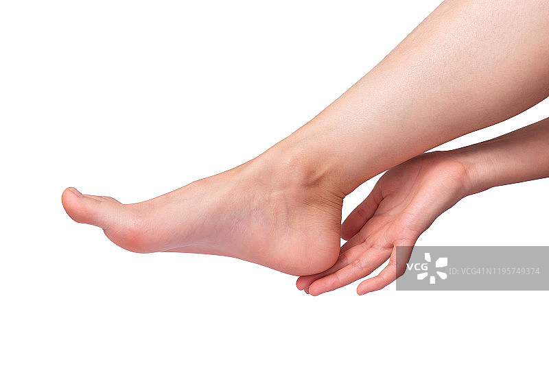 完美的女性脚在白色的背景。手触摸优雅的腿。Spa，足部护理理念。图片素材