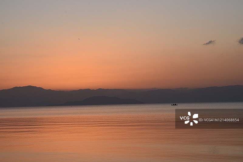 琵琶湖有日出和小船的剪影图片素材