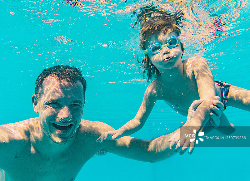 父亲和孩子在游泳池里图片素材