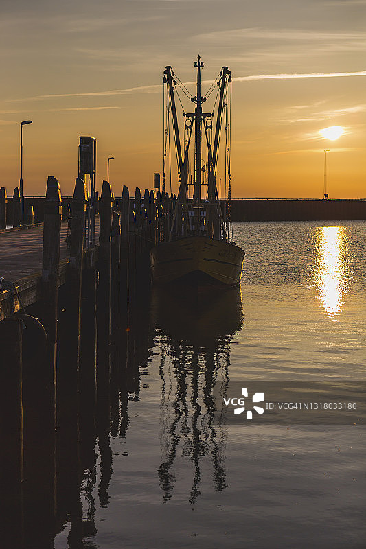 丹麦，罗摩，日落时分，渔船停泊在木码头上图片素材