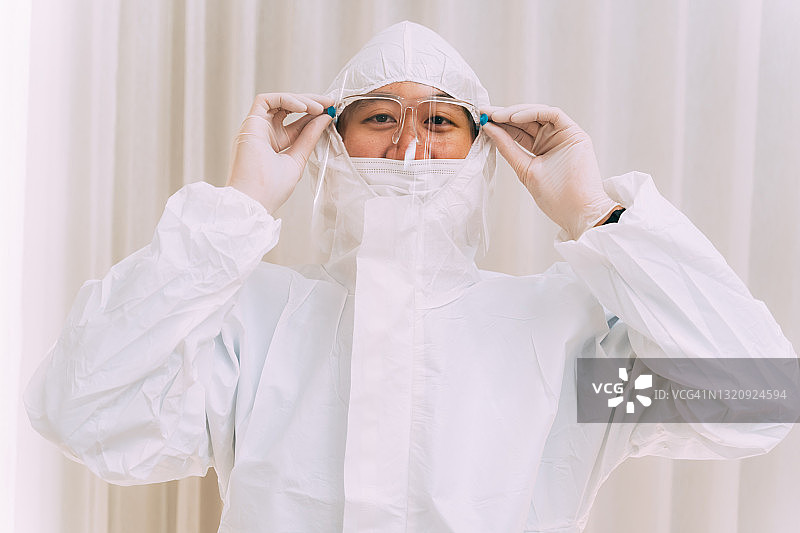 戴眼镜的医生穿着冠状病毒制服图片素材