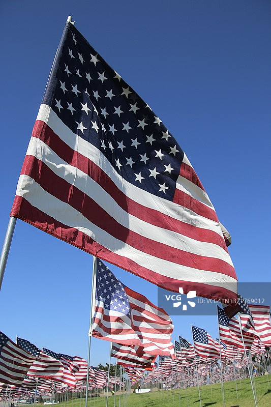 在加州马里布一个阳光明媚的日子里，美国国旗在风中飘扬图片素材