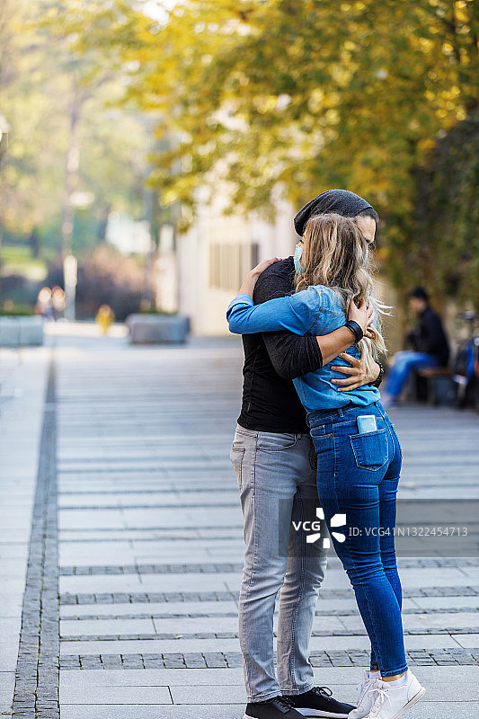 一个年轻的女人和她的男朋友在一起度过了美好的一天，漫步在城市的街道上。图片素材