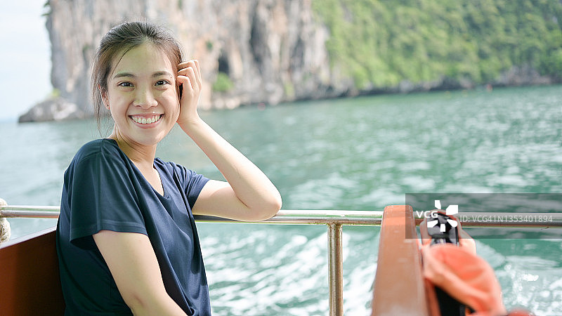 年轻的亚洲女人旅行热带海滩海乘坐公共交通渡轮在川和甲米泰国海滩海旅行图片素材