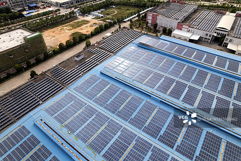 工厂屋顶的高角度视图与太阳能电池板图片素材