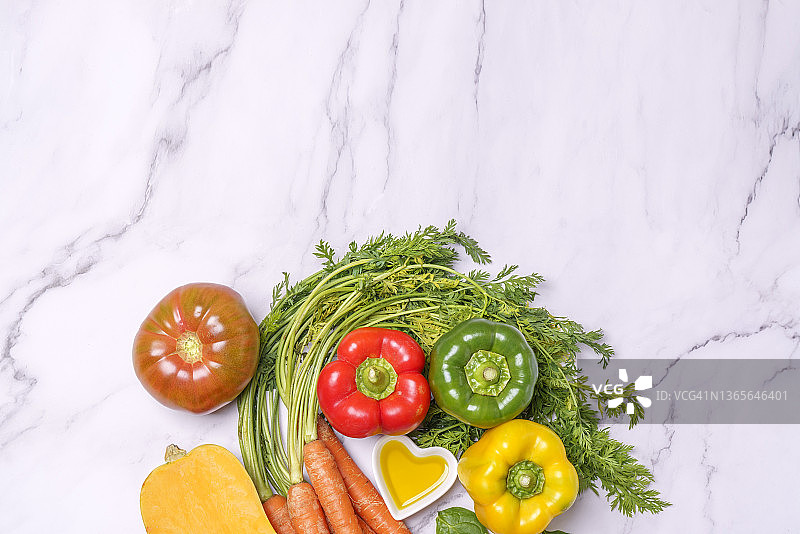 蔬菜和心形碗与橄榄油在大理石表面图片素材