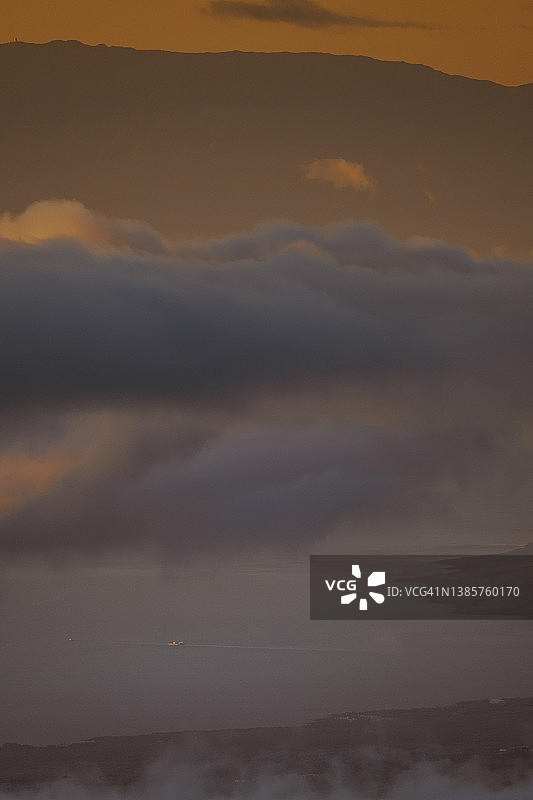 日落时分，一艘遥远的大船从空中驶入夏威夷大岛的港口图片素材
