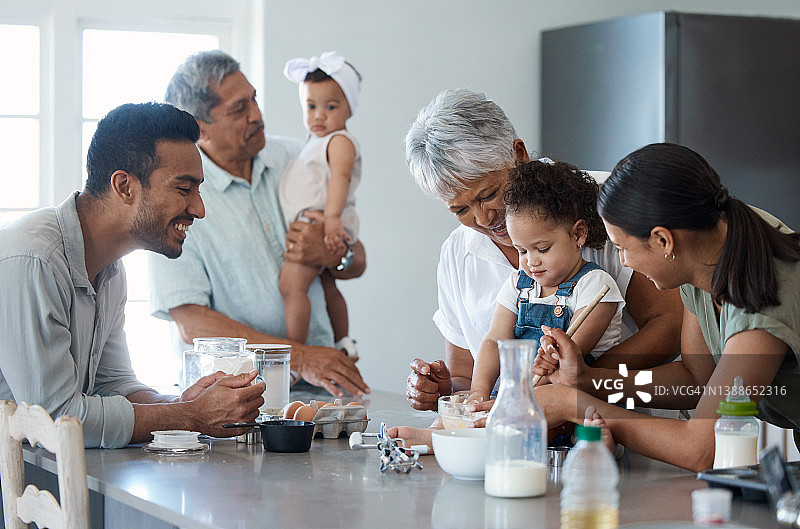 这张照片拍摄的是一个几代人的家庭在厨房里一起烘焙图片素材