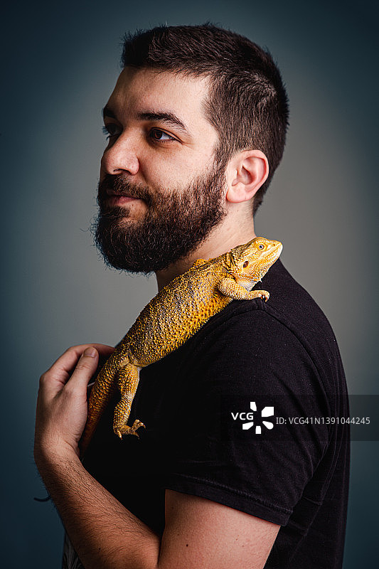 一个男人的肖像与他的宠物胡须龙图片素材