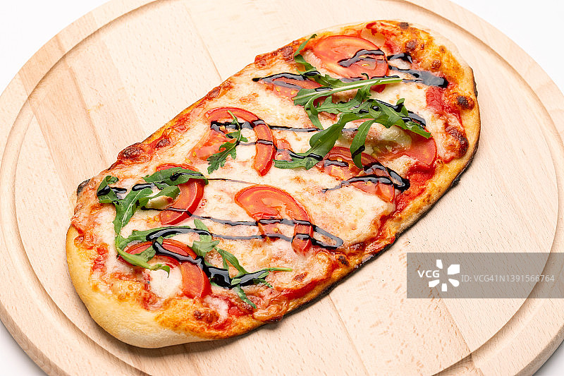美味的披萨装在木盘子里。概念广告传单和海报的餐厅或披萨店，模板与美味的口味。图片素材