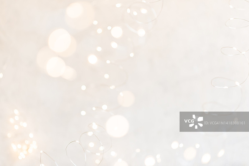 白色的圣诞彩灯在明亮的背景上模糊不清图片素材