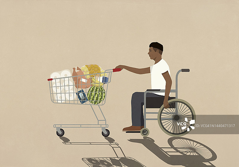 坐轮椅的男子推着购物车去杂货店购物图片素材
