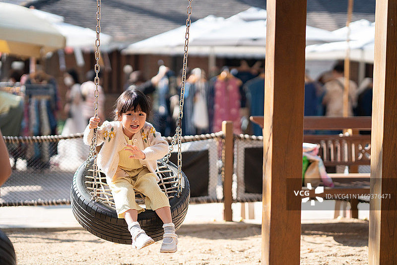 孩子的发展，韩国可爱的女孩孩子喜欢玩秋千操场，通过玩耍促进身心的发展图片素材