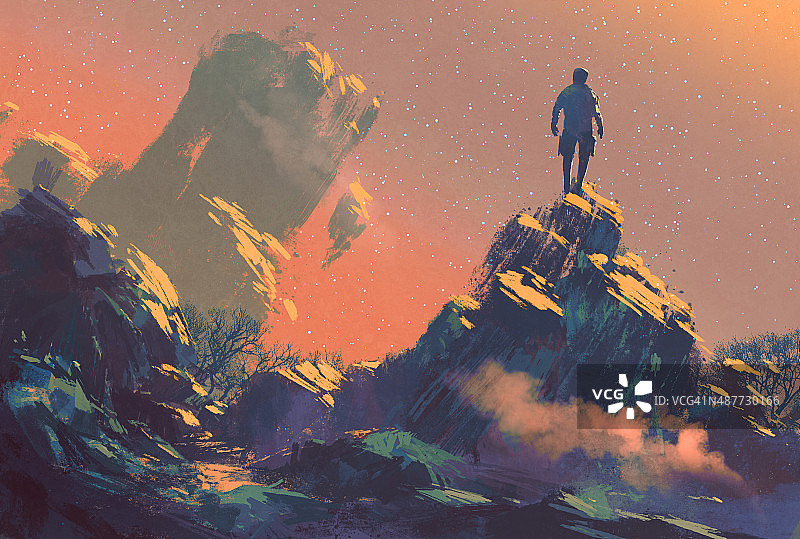一个人站在山顶上看星星图片素材