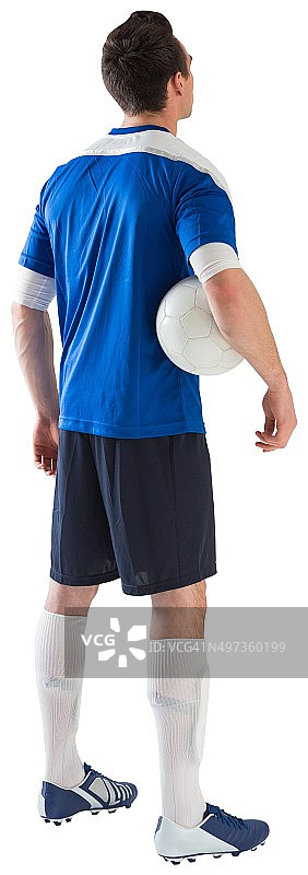 穿着蓝色球衣的帅气足球运动员图片素材
