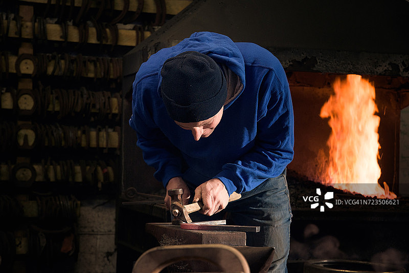 蹄铁匠在铁砧上锻造马蹄铁图片素材