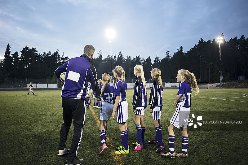 教练在球场上对着天空解说女子足球队图片素材
