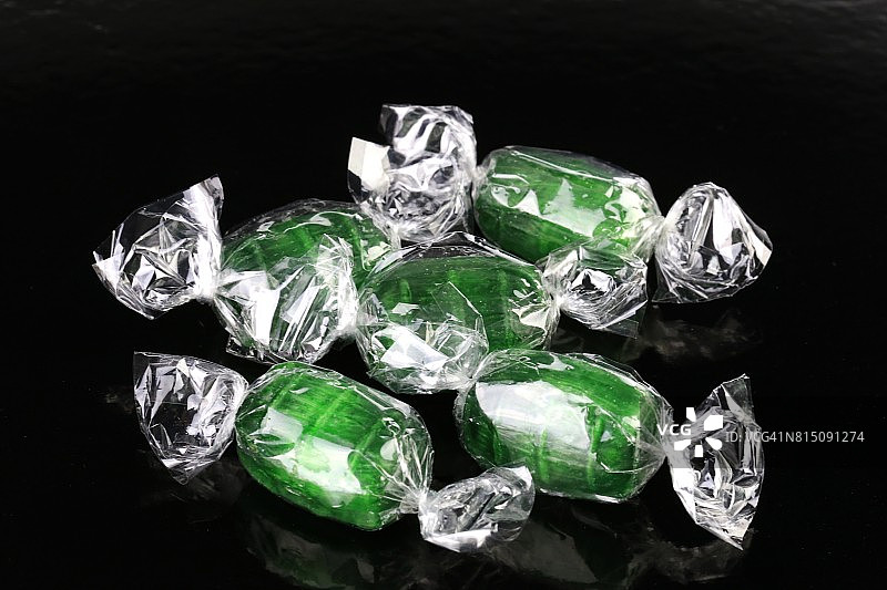 绿色的糖果在黑色的背景图片素材