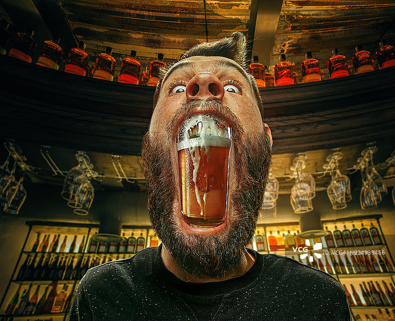 酒吧里男人嘴里的啤酒图片素材