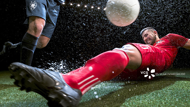 试图滑倒对手的足球运动员图片素材