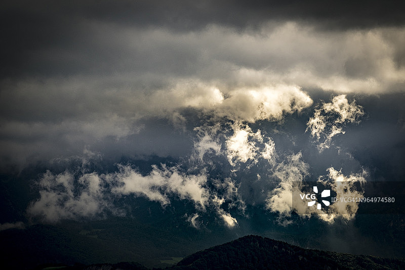 低角度的风景多云的天空在剪影山图片素材